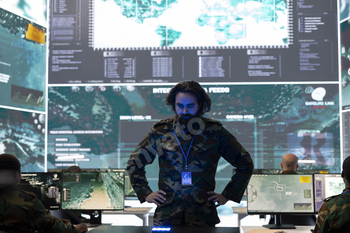 Specific operations engineer reviewing battlefield recordsdata on a hologram