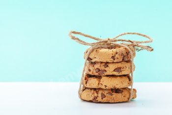 chocolate chunk cookies on a colourful blue background