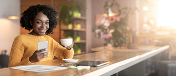 Younger businesswoman speaking to prospects whereas espresso break at cafe